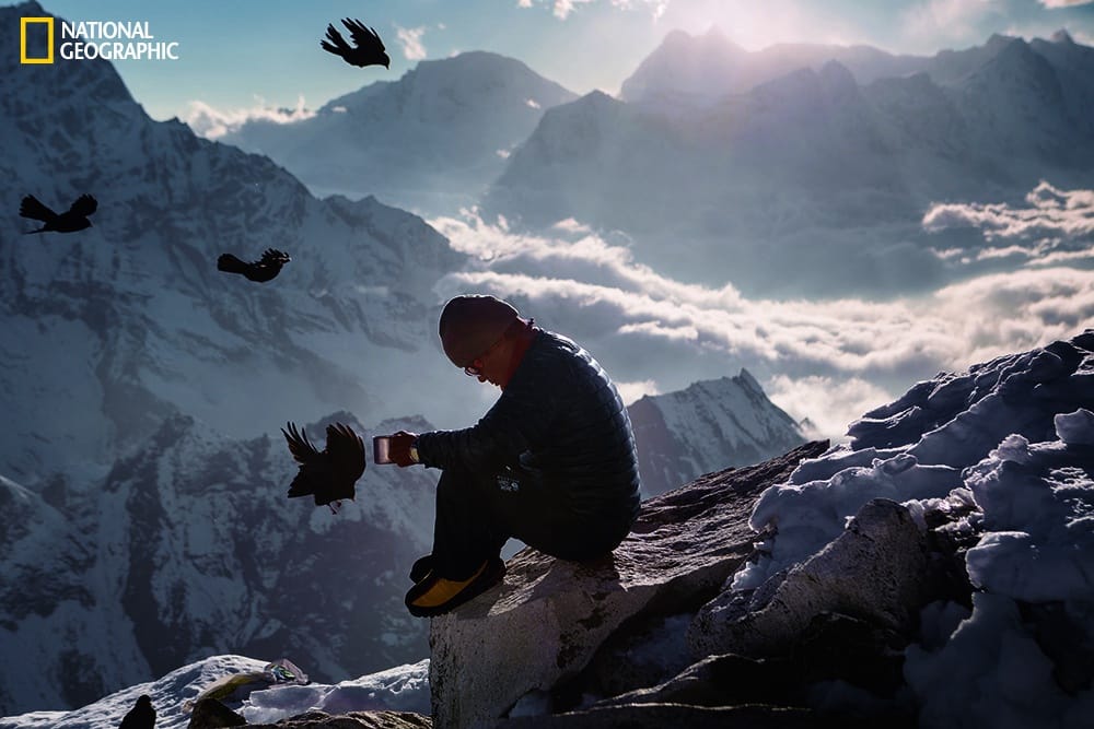 Photo by Aaron Huey/National Geographic Birds ride the wind as Lakpa Sherpa, a guide and expedition company owner, pauses for tea and a moment of reflection in 2013 among the peaks near Everest.