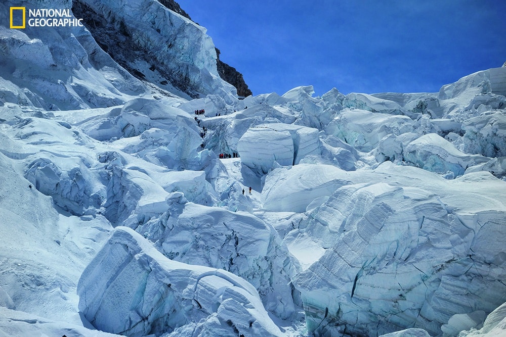 Photo by Andy Tyson/National Geographic April 18, 2014 Rescuers in the Khumbu Icefall dig for survivors and bodies among mansion-size blocks of ice about three hours after the avalanche. Eleven of the 16 victims died at a single spot at upper left, where climbers are searching.